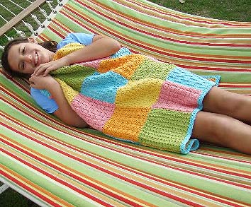 Finished Measurements: 29 inches by 32 &frac12; inches  Yarn: Spud & Chlo&euml; Sweater (55% superwash wool, 45% organic cotton; 100 grams/160 yards), 2 skeins each in Pollen #7508, Grass #7502, Splash #7510, Firefly #7505 and Watermelon #7512  Needles: US size 7 needles or the size needed to obtain the gauge (I used a 24-inch circular to work back and forth for the squares and edging.)  Gauge: 5 stitches per inch